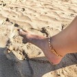 model wearing Oversized Flat Curb Chain Anklet on the beach