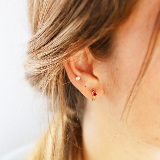 Crystal Red Heart Huggie Hoops in Gold on Model