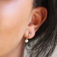 Polished Heart Huggie Hoop Earrings in Gold on Model