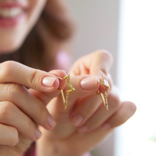 Hands Holding a Pair of Ladies' Rainbow Crystal Star Outline Hoop Earrings