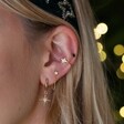 Shooting Star Huggie Hoops in Gold on a Curated Ear