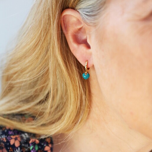 Model Wearing Tiny Teal Enamel Heart Charm Huggie Hoop Earrings