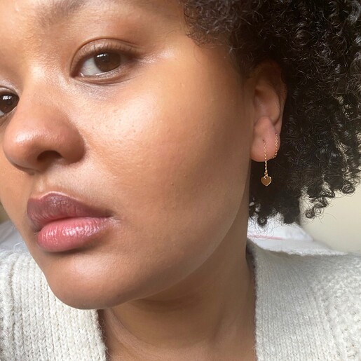 Model Wears Thread Through Mismatched Heart Earrings