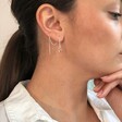 Model Wears Thread Through Mismatched Heart Earrings in Silver