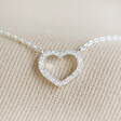 Close up of Delicate Crystal Heart Outline Necklace in Silver detailing
