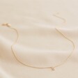 Full Length Shot of Tiny Pearl Initial Charm Necklace in Gold