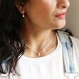 Lisa Angel Enamel White Pearl Necklace With Wing Charm in Gold On Model