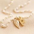 Close Up of Personalised Enamel White Pearl Necklace with Wing Charm
