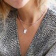 Model Wearing Personalised Tiny Hammered Tag Pendant Necklace with Birthstone Charm