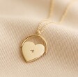 Delicate Spinning Heart Pendant Necklace in Gold on Fabric