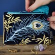 Model Holding House of Disaster Luxe Peacock Coin Purse