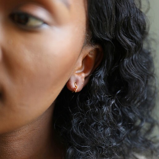 Girls Mini Gold Sterling Silver Star Huggie Hoop Earrings on Model