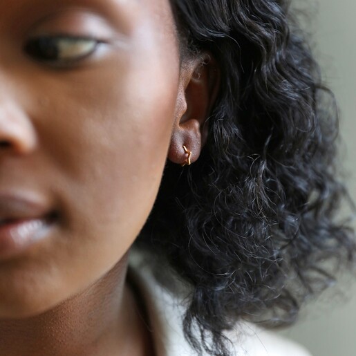 Mini Gold Sterling Silver Star Huggie Hoop Earrings on Model