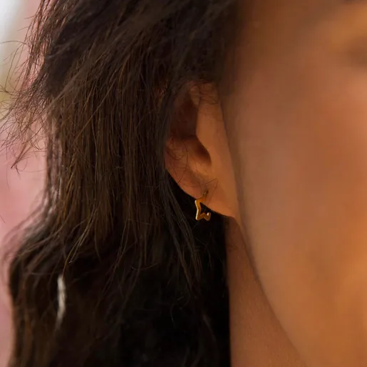 Model Wearing Ladies' Lisa Angel Mini Sterling Silver Star Huggie Hoop Earrings