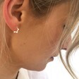 Lisa Angel Women's Small Mini Sterling Silver Star Huggie Hoop Earrings on Model
