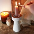 Model Lighting Candle in Stamped White and Terracotta Candlestick Holder