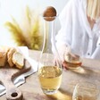 Slim Wine Carafe with Small Oak Stopper on Table With White Wine Inside