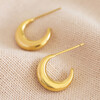 Gold Stainless Steel Moon Hoop Earrings Laying Flat on Cloth