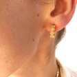 Model Wearing Ladies' Crystal Daisy Hoop Earrings in Gold