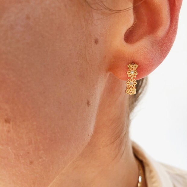 Model Wearing Crystal Daisy Hoop Earrings in Gold