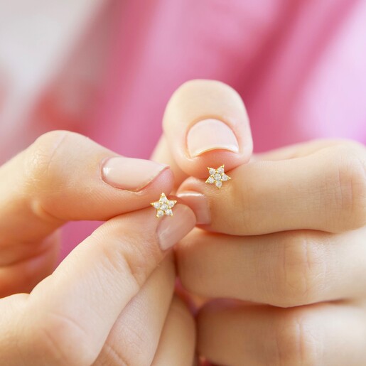 Model Holding Lisa Angel Crystal Star Stud Earrings in Gold