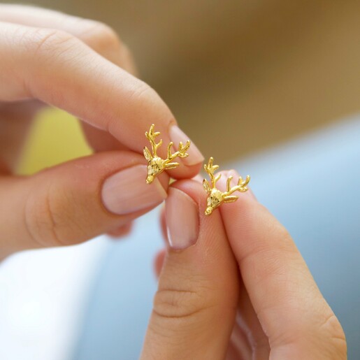 Model Holding Lisa Angel Stag Stud Earrings in Gold