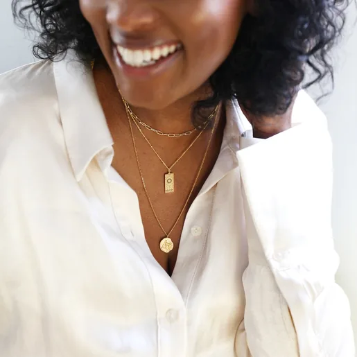 Model Wearing Ladies' Gold Stainless Steel Sagittarius Pendant Necklace in Packaging