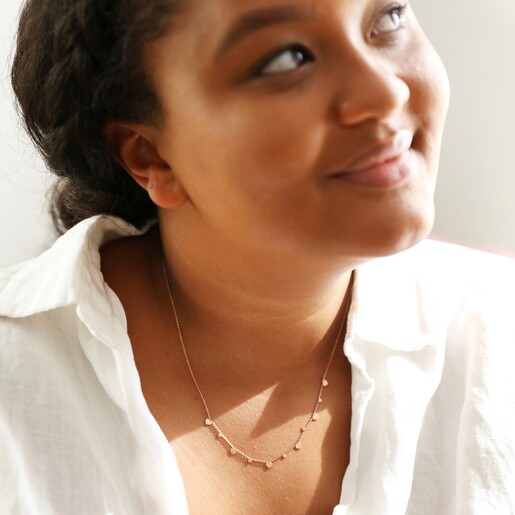 Female Model Wearing Stainless Steel Heart Charm Necklace in Rose Gold