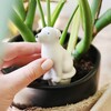 Model Holding Dog Plant Watering Spike