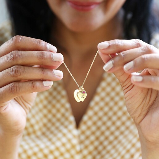 Model Holding Gold Personalised 40th Birthday Double Heart and Birthstone Necklace