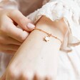 Close up of Lisa Angel Personalised Tiny Star Charm Bracelet on Model