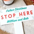 Close Up of White Personalised Acrylic Father Christmas Please Stop Here Sign
