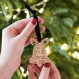 Model Holding Personalised No Place Like Home Wooden Bell Hanging Decoration