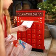 Child Posting Letter to Santa in Personalised Fill Your Own Postbox Advent Calendar