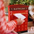 Model Pushing Letter to Santa Through the Personalised Fill Your Own Postbox Advent Calendar