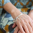 Model Holding 'Grandma' Meaningful Word Bangle in Silver From Lisa Angel