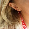 Close Up Of Model Wearing Gold Sterling Silver Crystal Bar Huggie Hoop Earrings From Lisa Angel