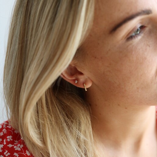 Model Wearing Ladies' Gold Sterling Silver Dotted Huggie Hoop Earrings From Lisa Angel