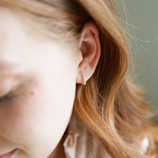 Sterling Silver Dotted Huggie Hoop Earrings in Gold on Model From Lisa Angel