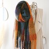 Thick Burgundy, Navy and Mustard Winter Scarf Hanging on Coat Stand