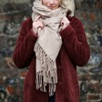 Model wearing beige Personalised Starry Initials Lambswool Scarf with red coat