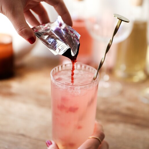 Pouring Mix from Pinkster Gin Jam 20g Cocktail Mix Sachet into Drink