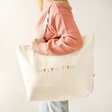 Model Holds Personalised Embroidered Rainbow Wording Organic Cotton Tote Bag