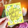 Model Holding Welcome Baby Greeting Card