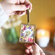 Model Holding Personalised Mini Brass Hanging Frame with Pressed Flowers