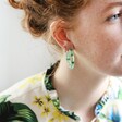 Model Wearing Bright Chunky Dried Flower Resin Hoop Earrings in Green
