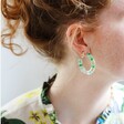 Model Wearing Dried Flower Resin Hoop Earrings in Green