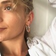 Model Wearing Dried Flower Resin Hoop Earrings in Pink