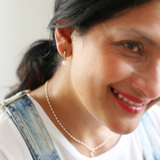 Model Wearing Lisa Angel Glass Pearl Huggie Hoop Earrings in Gold