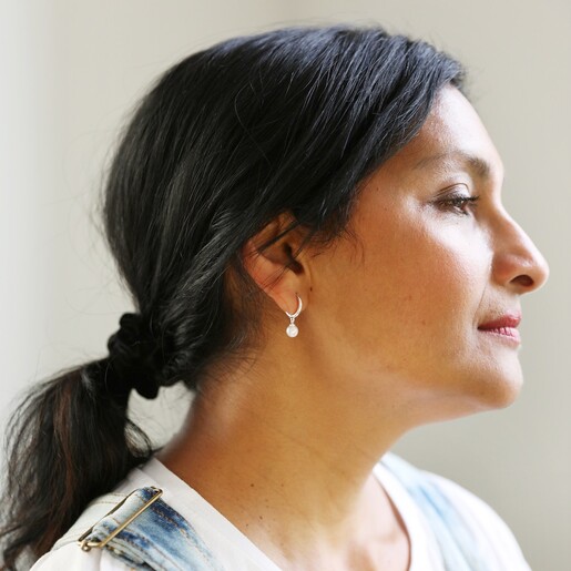 Model Wearing Glass Pearl Huggie Hoop Earrings in Silver